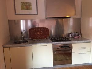 a kitchen with a sink and a stove top oven at B&B san Biagio parma in Parma +2 photos