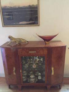 a cabinet with a cheetah sitting on top of it at B&B san Biagio parma in Parma