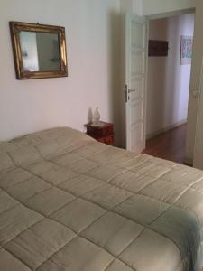 a bedroom with a large bed and a mirror at B&B san Biagio parma in Parma +4 photos