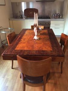 a kitchen with a wooden table with candles on it at B&B san Biagio parma in Parma