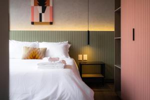 a bedroom with a bed with white sheets at Outsite Mexico City Roma Sur - Work, Connect, Explore in Mexico City