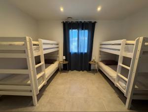 een kamer met 3 stapelbedden en een raam bij Villa Hestia in Goudargues +21 foto's