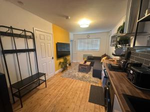 a room with a kitchen and a living room at 1a Woodlands Edge in Trowbridge