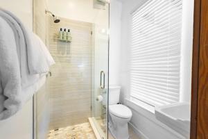 a bathroom with a shower and a toilet and a sink at Curry House - Pool, King Bed & Balcony! Room 7 in Key West