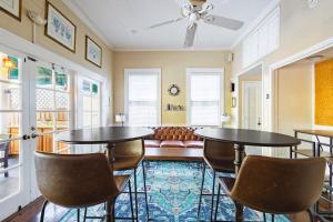 two tables and chairs in a room with a couch at Curry House - Pool, King Bed & Balcony! Room 7 in Key West +6 photos