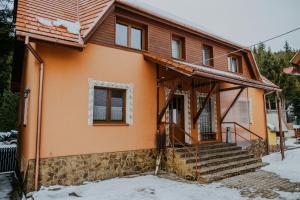 a home under construction in the snow at Zafir House Harghita Bai Ski in Harghita-Băi