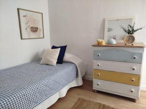 a bedroom with a bed and a dresser at Casa Sebadal in La Santa