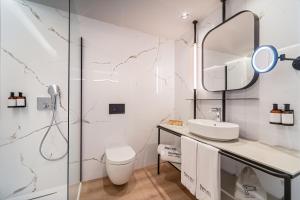 a bathroom with a sink and a mirror at Barcelo Valladolid in Valladolid +5 photos