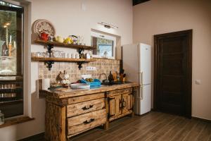 a kitchen with a wooden counter and a refrigerator at Zafir House Harghita Bai Ski in Harghita-Băi