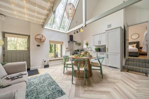 a kitchen and living room with a table and chairs at Birch Studio in Camborne