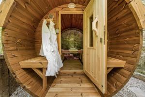 a wooden sauna with two benches and a door at Birch Studio in Camborne