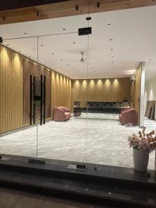 a large room with glass walls and a stage at Troy Resorts and wellness in Zirakpur