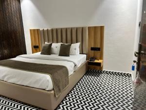 a bedroom with a large bed in a room at Troy Resorts and wellness in Zirakpur