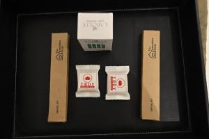 a black tray with three different types of food items at Troy Resorts and wellness in Zirakpur +7 photos