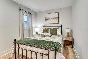 a white bedroom with a bed and a window at Game Room and Backyard Modern Altoona Home! in Altoona
