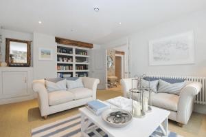 a living room with two couches and a table at The Tide House in St Ives