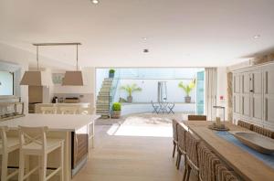 a kitchen and dining room with a table and chairs at The Tide House in St Ives