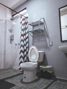 a bathroom with a toilet and a shower and a sink at Hotel Zepeda in Ocosingo +39 photos
