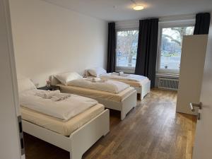 Ένα ή περισσότερα κρεβάτια σε δωμάτιο στο CityStay Cologne Apartments & Rooms