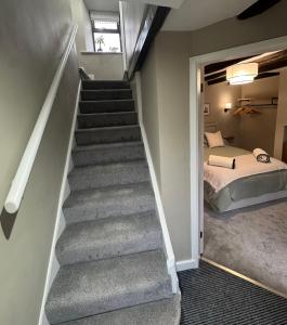 a stairway leading to a bedroom with a bed and a bed sqor at 1 Gilmore Close in Alston