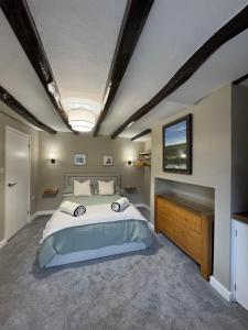 a bedroom with a large bed and a window at 1 Gilmore Close in Alston
