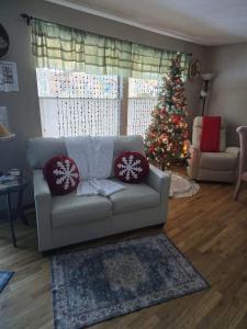 a living room with a christmas tree and a couch at Roaring Fork Retreat home in Glenwood Springs
