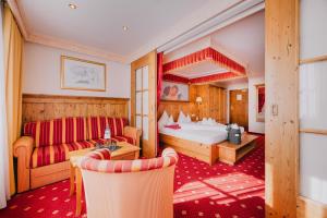 a hotel room with a bed and a couch at ... mein romantisches Hotel Toalstock in Fiss +172 photos