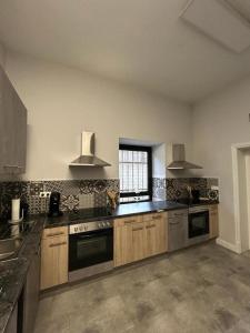 a large kitchen with wooden cabinets and a window at Sia Apartments Hotel in Essen +92 photos