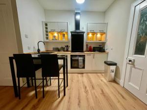 a kitchen with a table and chairs in a room at The Nairn Neuk - Couples Cosy Getaway in Nairn +1 photo