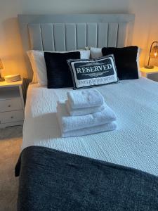 a bed with two pillows on top of it at The Nairn Neuk - Couples Cosy Getaway in Nairn