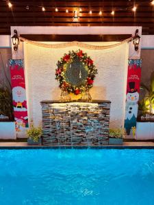 a wreath on a wall next to a swimming pool at 8 Plus Motels in Negombo