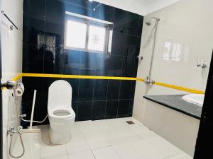 a bathroom with a toilet and a sink at OSMA Residency in Islamabad