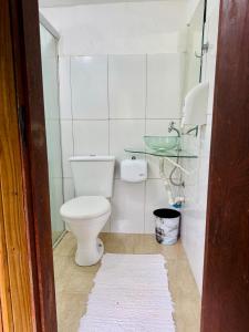 a small bathroom with a toilet and a sink at Mandacaru Pousada Arraial D'Ajuda in Arraial d'Ajuda +19 photos