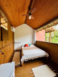 a room with two beds and a ceiling fan at Mandacaru Pousada Arraial D'Ajuda in Arraial d'Ajuda