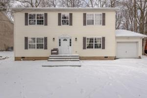 a house with a snow covered driveway in front of it at Lakeview Family Retreat Newly Renovated 4BR House in Pocono Country Place