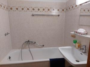 een badkamer met een ligbad en een wastafel bij Antoinette Kurappartement in Bad Krozingen +3 foto's