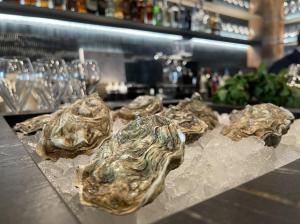 a group of oysters sitting on ice on a counter at Hotel Medinaceli New reopening 2025 in Barcelona