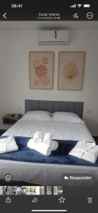 a picture of a bed with two towels on it at Home Aguas da barra Ilhabela in Ilhabela