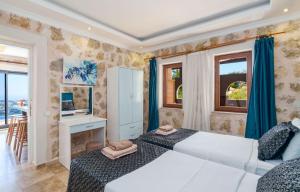 a bedroom with two beds and a desk and windows at Villa Elvin in İslâmlar +41 photos