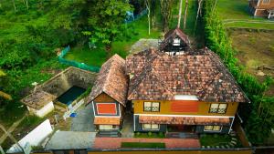 an overhead view of a house with a roof at Vipinam, The riverside retreat in Kotamangalam