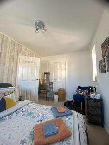a bedroom with a bed with two towels on it at Mel house in Fife