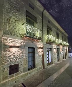 a building with lights on the side of it at night at Apartamentos LA CAÑADA DE OSMA in El Burgo de Osma