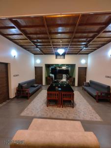 a living room with a pool table and couches at Vipinam, The riverside retreat in Kotamangalam