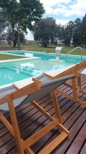 a picnic table on a deck next to a swimming pool at complejo cumelen in Gualeguaychú