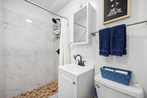 a bathroom with a white toilet and a sink at Highly Recommended Studio Near Times Square in New York
