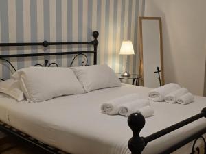 a bedroom with a bed with towels on it at MR House - by Be Your Home in Rome