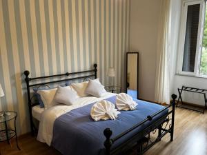 a bedroom with a bed with two pillows on it at MR House - by Be Your Home in Rome