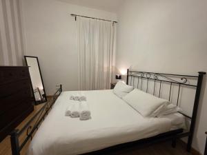 a bedroom with a bed with two pairs of shoes on it at MR House - by Be Your Home in Rome +30 photos