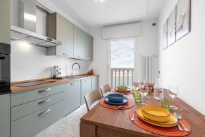 een keuken met een houten tafel met borden erop bij Casa Gabbiano by Ca-sa Check in Chioggia