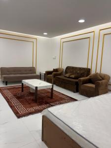 a living room with couches and a coffee table at Alawadhi Farm 1 in Ras al Khaimah